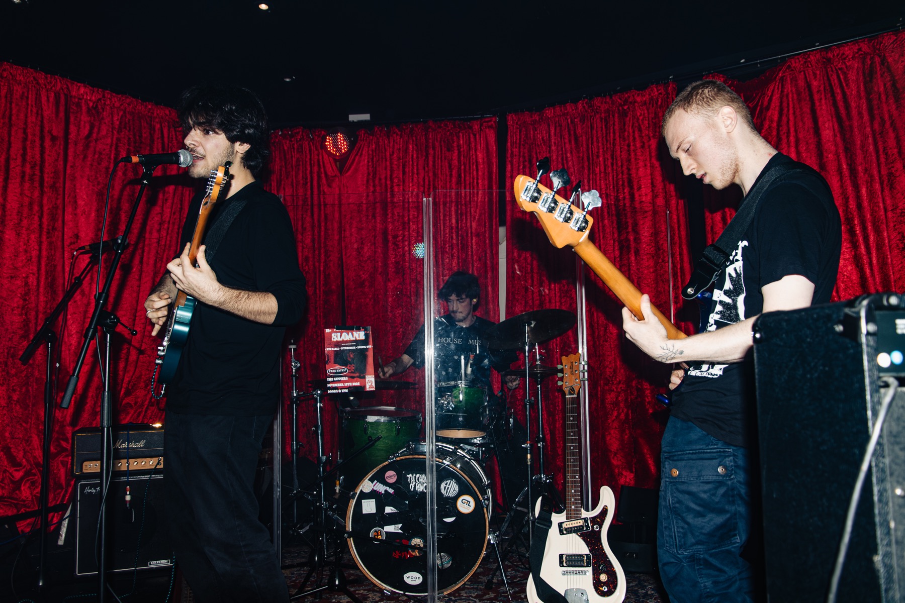 Zoning Out performing live with red curtains
